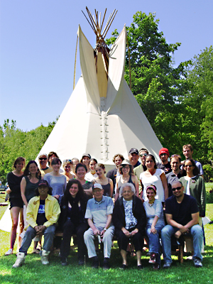 Students from Law, Social Work and Anthropology gather in front of a tipi with their professors and Elders.