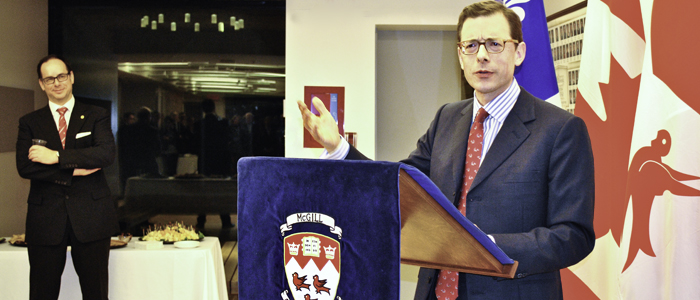 Robert Yalden speaking to the audience, with Dean Daniel Jutras in the background