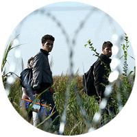 Migrants behind barbed wire