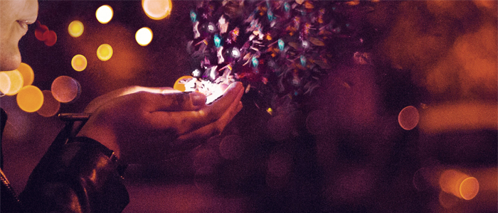 Detail of a photo of a woman blowing glitter from her hands at night by Almos Bechtold @almosbech via Unsplash