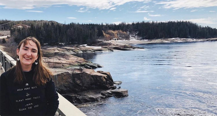 BCL/JD student Larissa Parker standing on a bridge over the Magpie River.